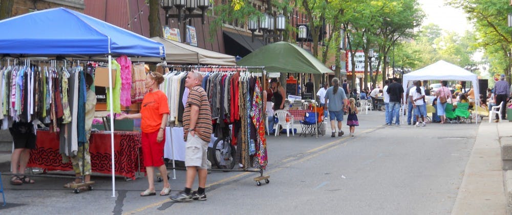Patrons visit street vendors at the Crossroads Music Festival June 11.