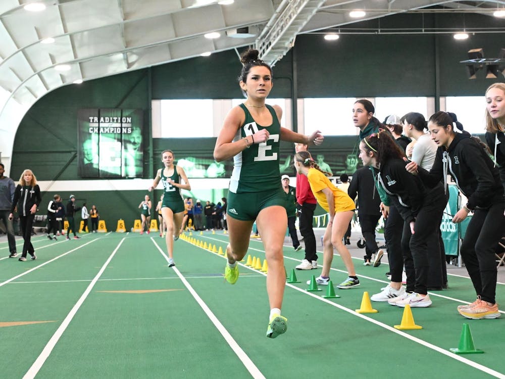 Eastern Michigan University distance runner Paige Marchant crosses the finish line for the Eagles. 