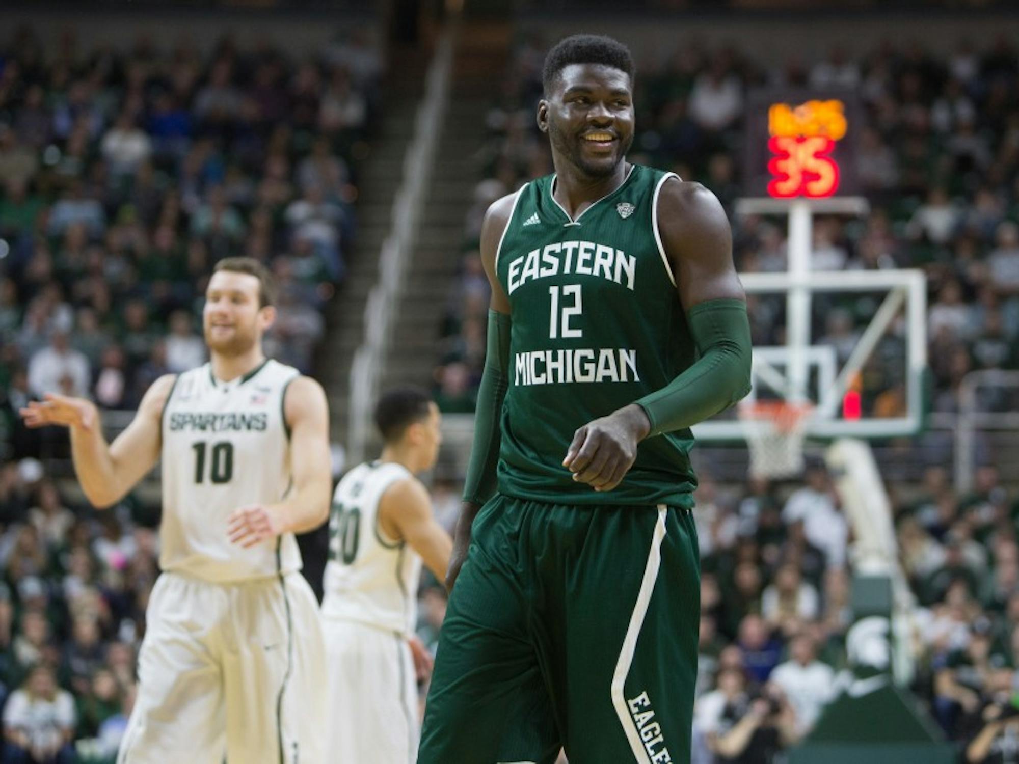 Eastern Michigan center Lekan Ajayi smiles at the bench after drawing a charge in their 66-46 loss to Michigan State in East Lansing Wednesday night.