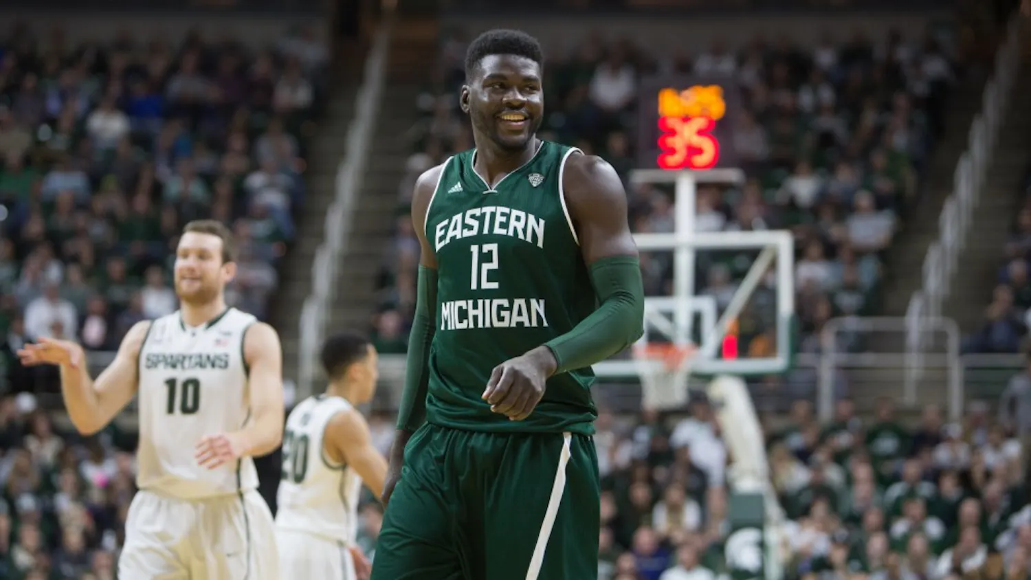 Eastern Michigan center Lekan Ajayi smiles at the bench after drawing a charge in their 66-46 loss to Michigan State in East Lansing Wednesday night.