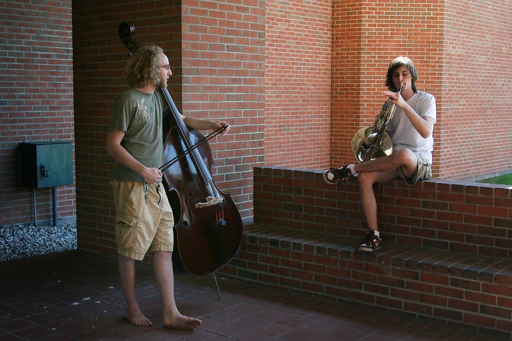 Music students Michael Edwards (left) and Michael Mesner practice outside of Alexander Hall. Music professor Joel Schoenhals will be performing “Fantasies, Part II” at 8 p.m. tomorrow in Pease Auditorium. Selections include music from Chopin and Schubert.
