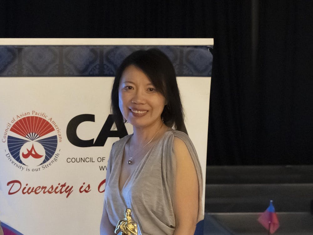 EMU Professor Tsu-Yin Wu accepting award at the Council of Asian Pacific Americans.