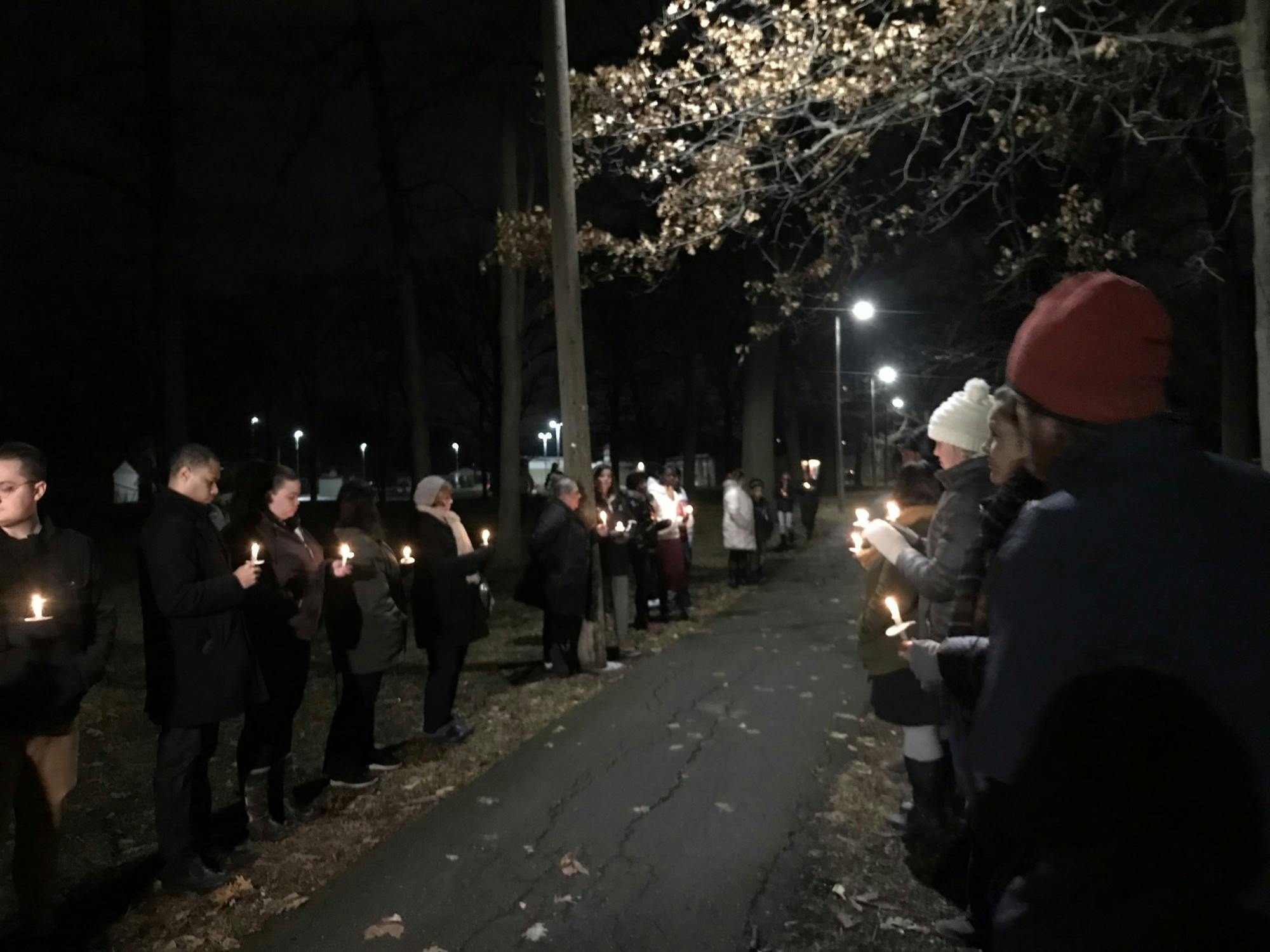 Mourners hold candles in remembrance of Brian "Trey" Matthews III. 