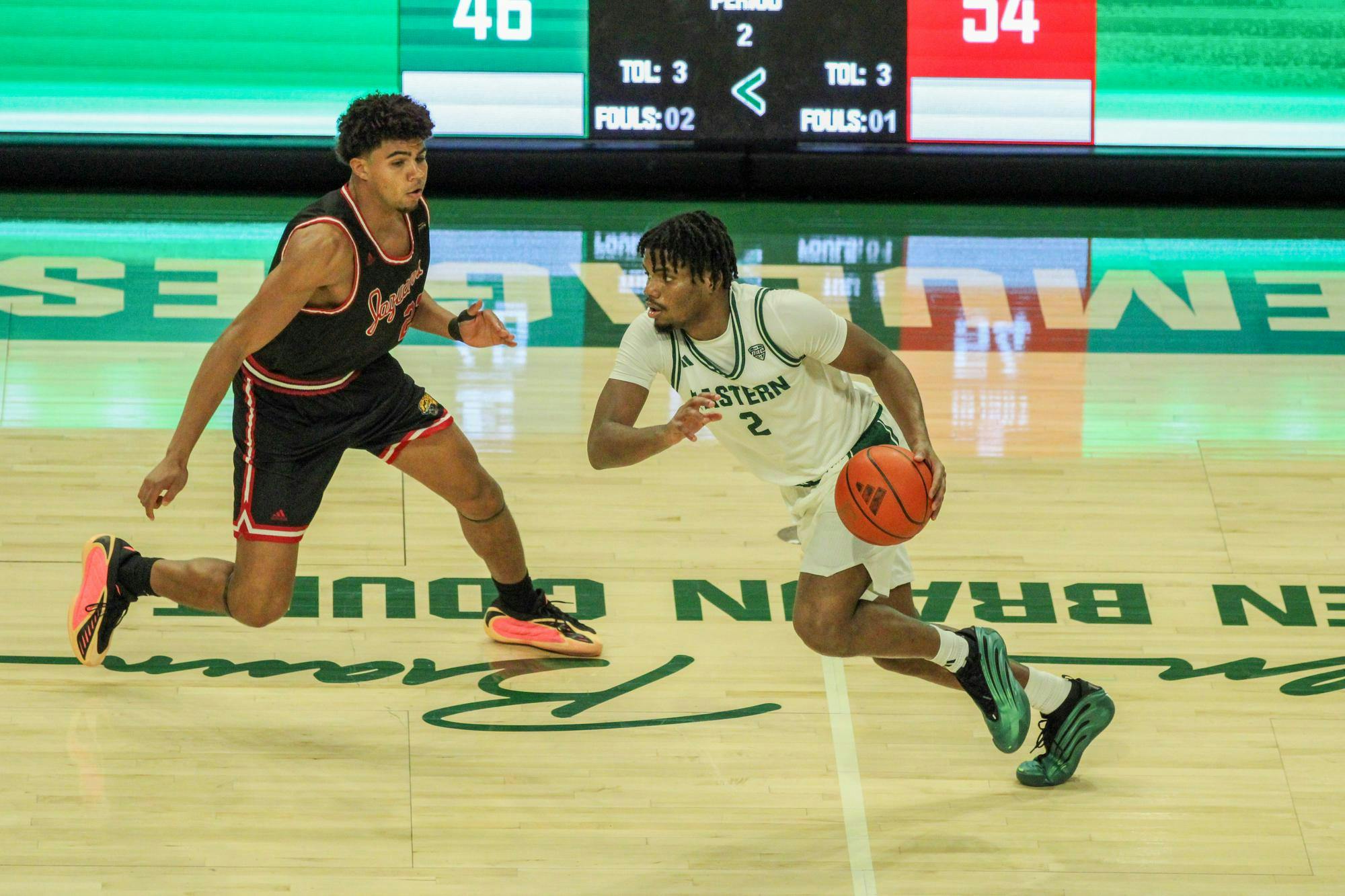#2, in a white jersey, dribbling the ball
