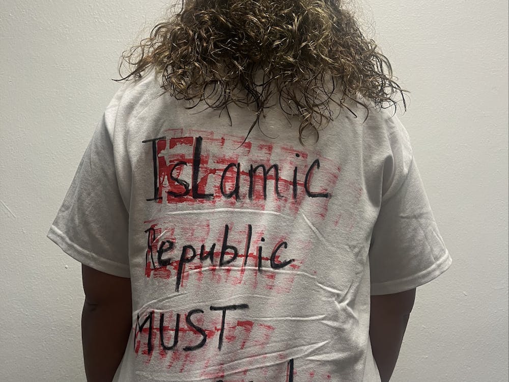 The back of EMU graduate student NeDa Hayeri's shirt reads "Islamic Republic must go!" 