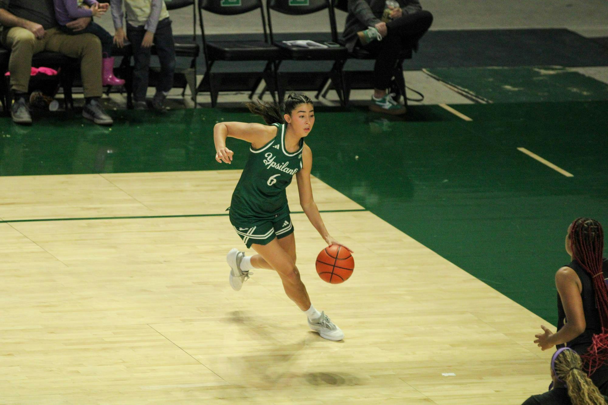 #6 Fernanda Ovalle, in a green Eastern Michigan University jersey, dribbling the ball.