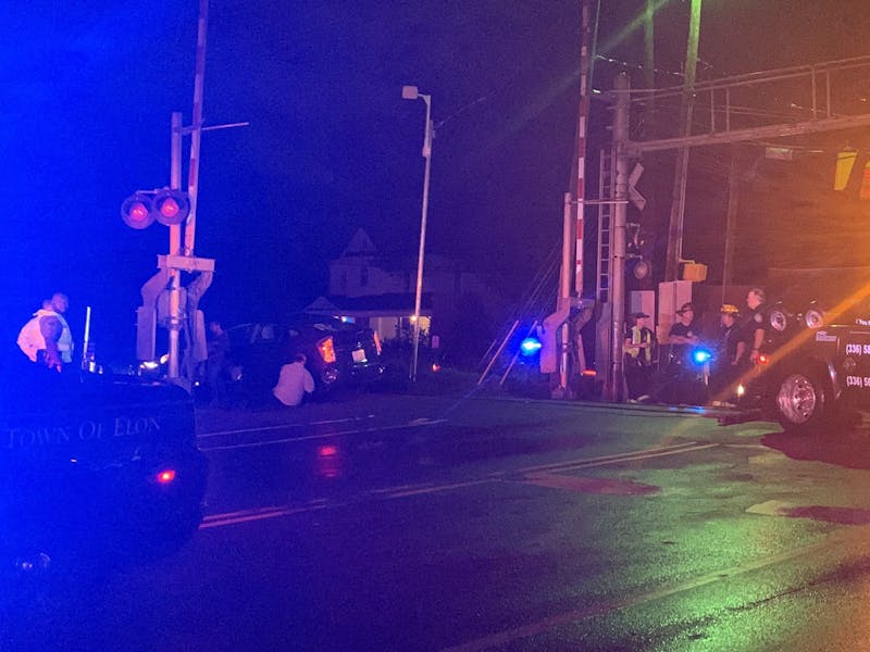 Car stuck on tracks at intersection of W Trollinger Ave. and N