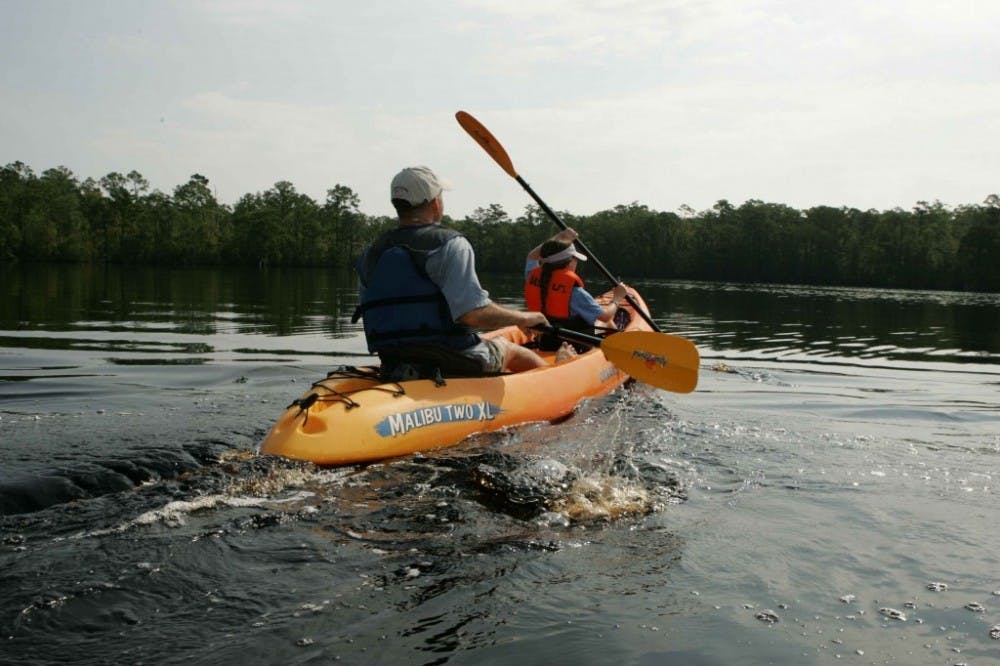 an-adult-and-child-enjoy-their-time-paddling-a-kayak