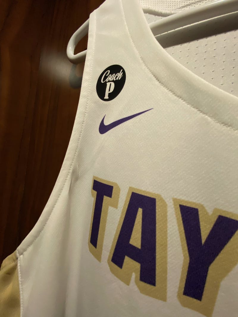 The Taylor men's basketball uniforms will display this patch honoring Paul Patterson throughout their season. 