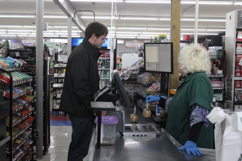 A Walnut Creek Country Market employee checks out a customer.