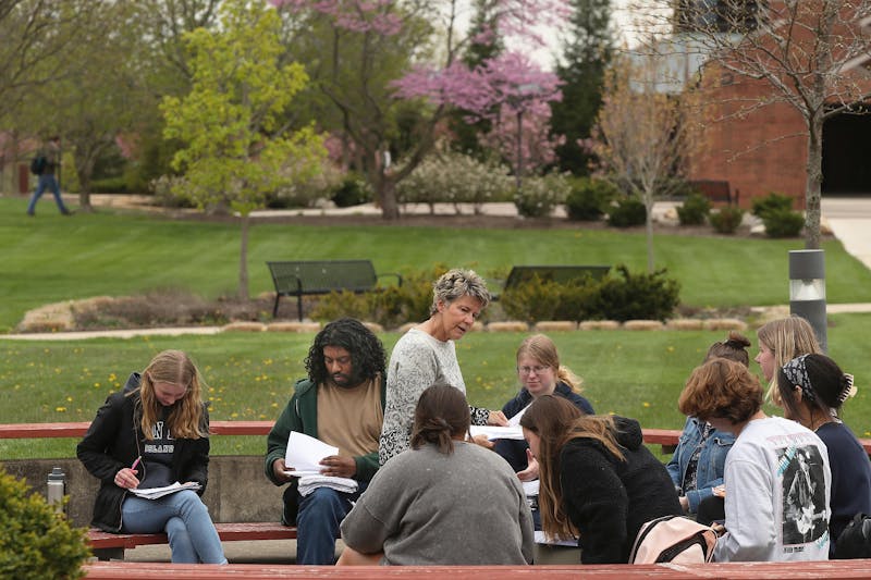 Taylor students enjoy class outdoors in the spring.