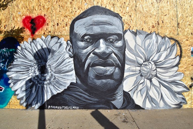 A mural to honor George Floyd painted on plywood in Minneapolis, MN.