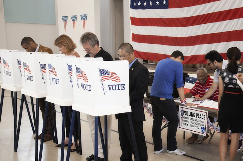 People voting in polling place --- Image by © Hill Street Studios/Blend Images/Corbis