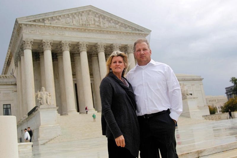 Michael and Chantell Sackett pose in front of the Supreme Court. (Photo provided by The New York Times)