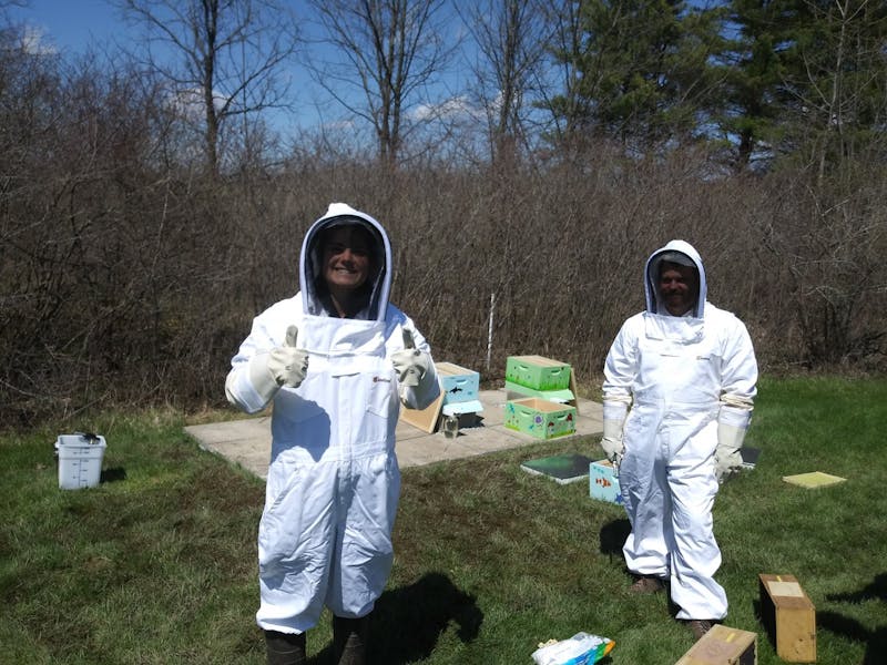 Junior Juniper Tucker and Director of Dining Services Nathaniel Malone pose in their bee suits. 
