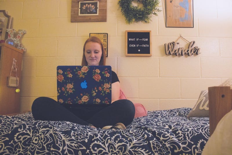 A student studies in her dorm room.
