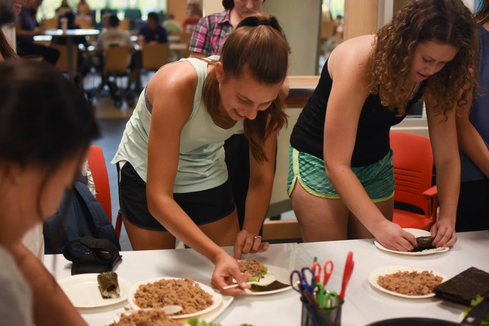 Students prep Korean food at Kimbap night in celebration of the new Korean classes.jpg