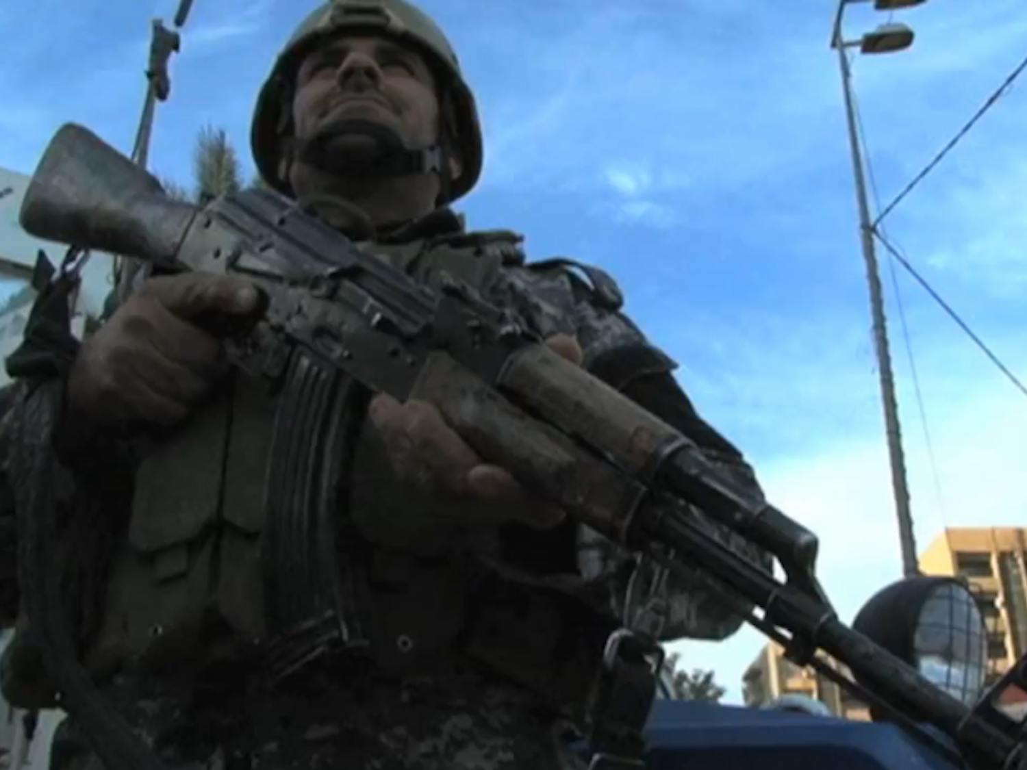 Baghdad_Iraq_during_the_post_withdrawal_insurgency_soldier_standing_guard.png