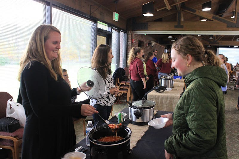 Olson Hall Director Jessie Woodring serves her soup to students at Empty Bowls.