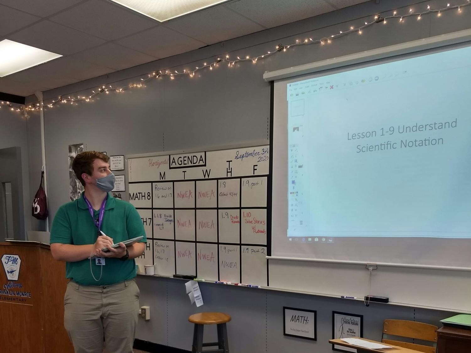 Senior Logan Tuckey engages with his math class while wearing a mask and being socially distanced.