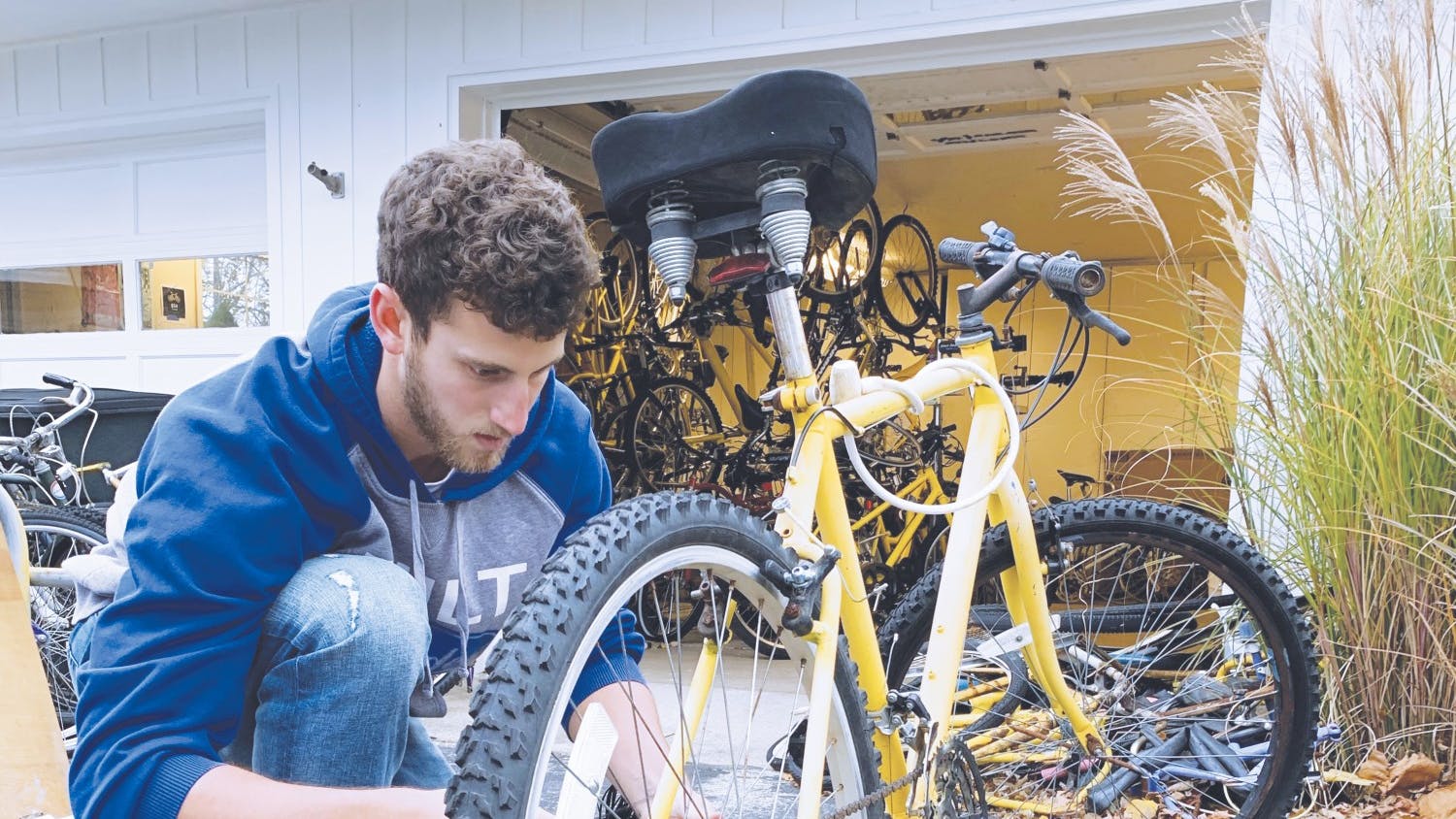 Matt Wildman works on tuning up the rental bikes before distribution PRINT.jpg