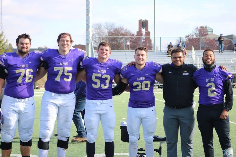 The football seniors smile after their 38-26 win against Lawrence Tech