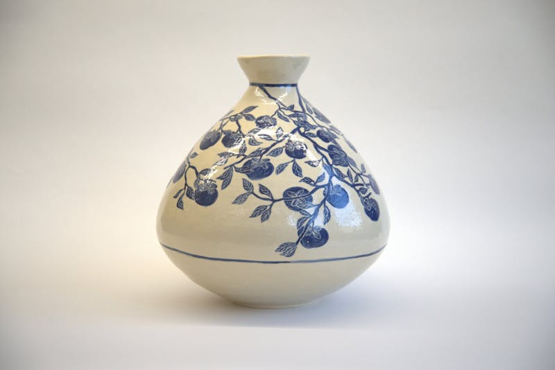 Katie Ito hand-sculpted and painted a vase which she titled, “Persimmon Summer.”
