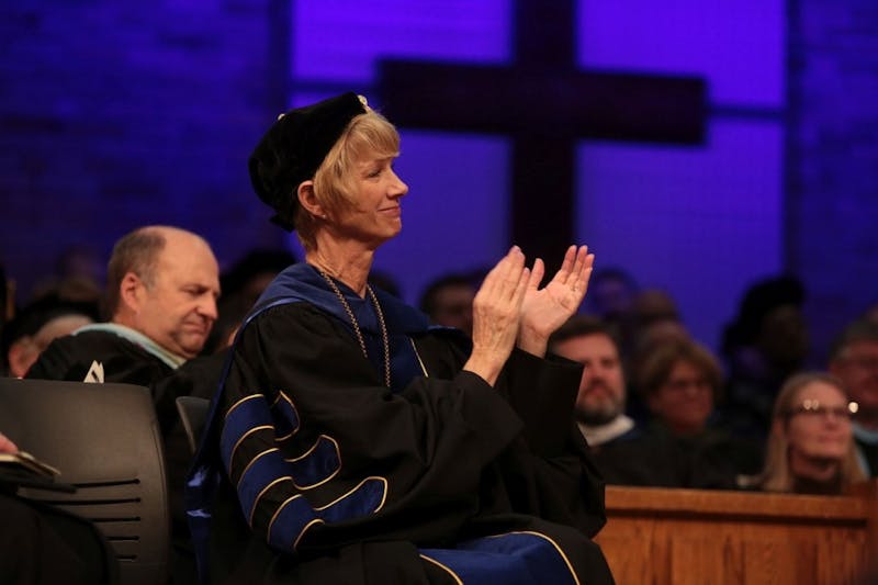 Dr. Paige Cunningham applauds during chapel service. 