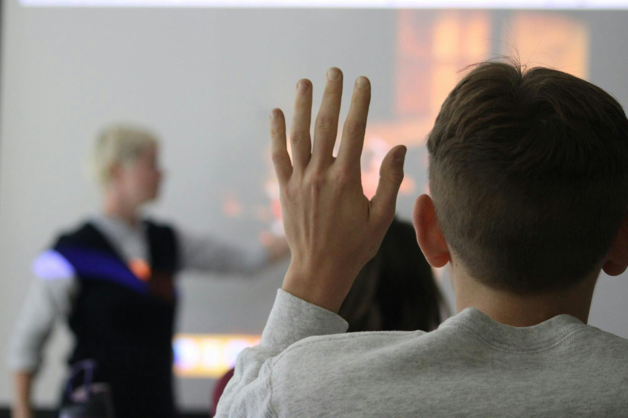 Student raises hand.JPG