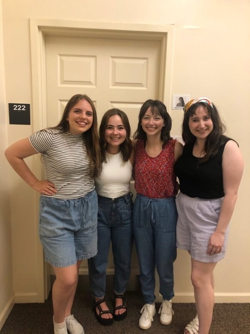 Madi Turpin, Ashley Anderson, Becah Schwartz, and author Katie Pfotzer outside of their senior apartment in Wolgemuth Hall.