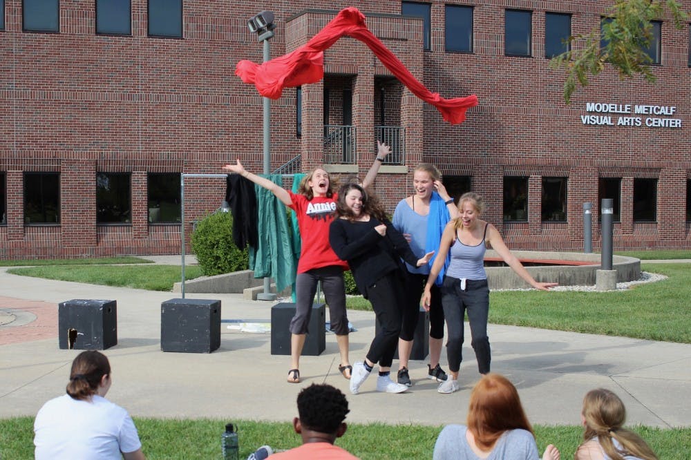 A group acts out the story of an audience member