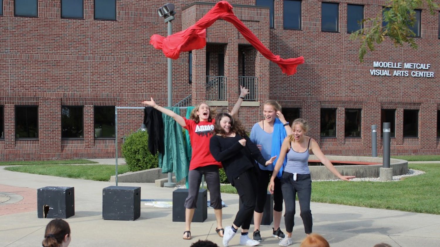 A group acts out the story of an audience member