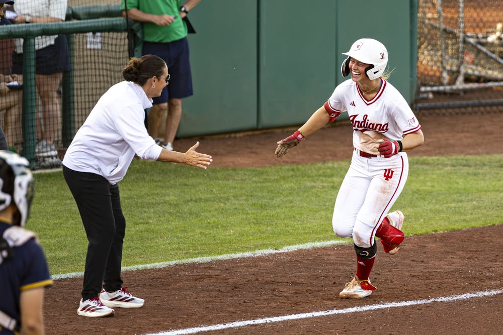 Alex Cooper smiles as she rounds third base and celebrates with head coach Shonda Stanton during Indiana's win over Notre Dame at Andy Mohr Field on Tuesday, April 14, 2026. (Photo by Brady Owen / The Hoosier Network)