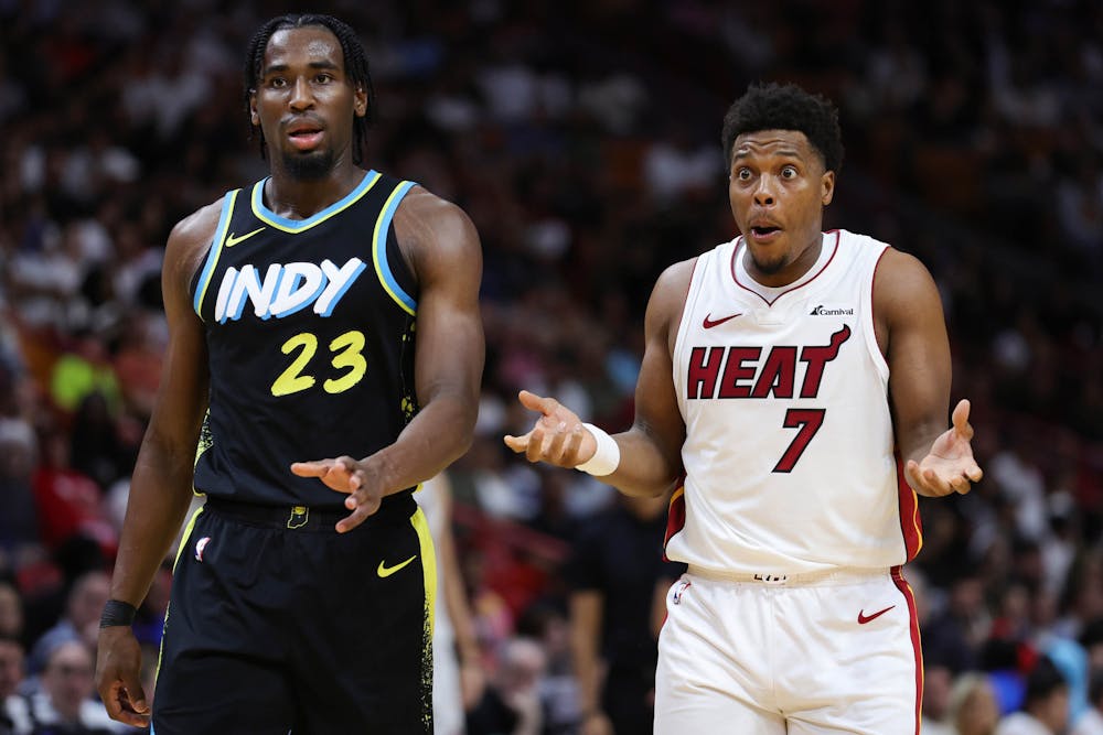 The Indiana Pacers' Aaron Nesmith (23) and the Miami Heat's Kyle Lowry (7) react to second-quarter action at Kaseya Center on Saturday, Dec. 2, 2023, in Miami. (Megan Briggs/Getty Images/TNS)