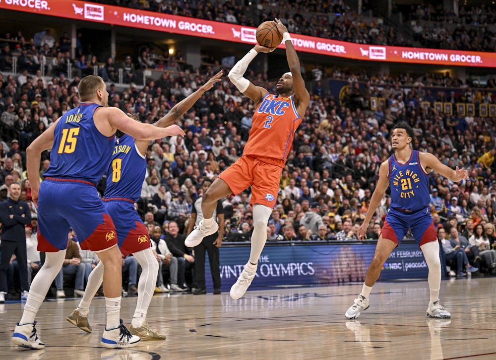 DENVER , CO - FEBRUARY 1: Shai Gilgeous-Alexander (2) of the Oklahoma City Thunder shoots over Nikola Jokic (15) and Peyton Watson (8) of the Denver Nuggets as Spencer Jones (21) watches during the first quarter at Ball Arena in Denver, Colorado on Sunday, February 1, 2026. (Photo by AAron Ontiveroz/The Denver Post/Tribune Content Agency)