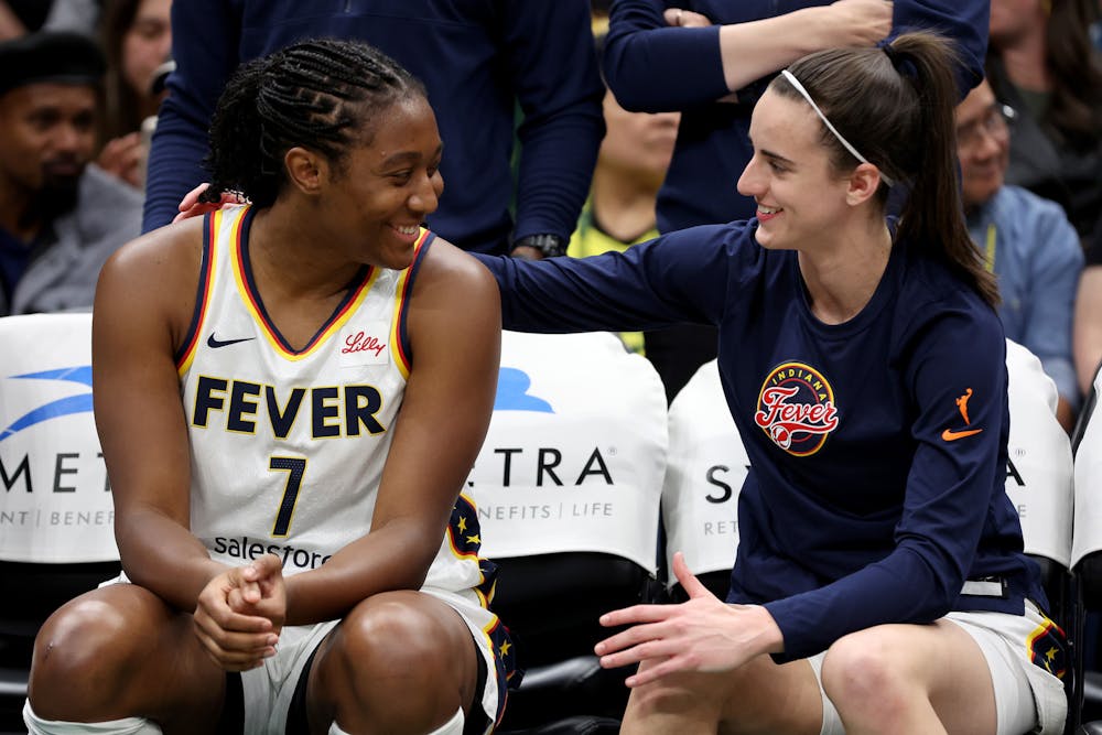 Aliyah Boston (7) and Caitlin Clark (22) of the Indiana Fever sit on the bench before the game against the Seattle Storm at Climate Pledge Arena on June 27, 2024, in Seattle. (Steph Chambers/Getty Images/TNS)