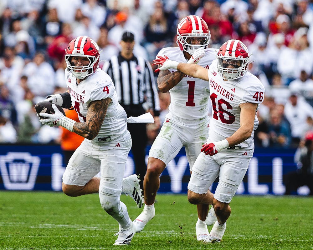 Indiana linebacker Aiden Fisher (4) returns an interception with fellow linebacker Isaiah Jones (46) lead blocking during Indiana's win at Penn State on Nov. 8, 2025. (HN photo/Kallan Graybill)