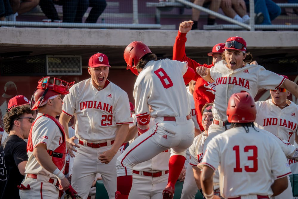 Indiana players greet Tyler Cerny (8) at home plate after a home run during Indiana's win over Butler on March 29, 2024. (HN photo/Danielle Stockwell)