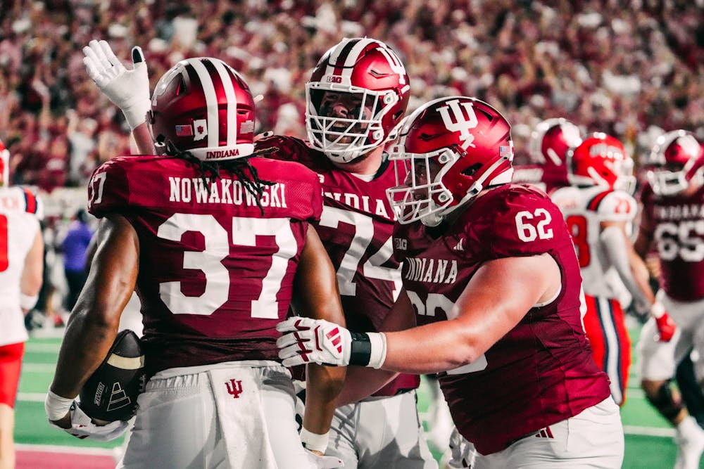 Bray Lynch (center) and Drew Evans (right) celebrate with 
Riley Nowakowski after a touchdown during Indiana's win over Illinois on Sept. 20, 2025. (HN photo/Shrithik Karthik)