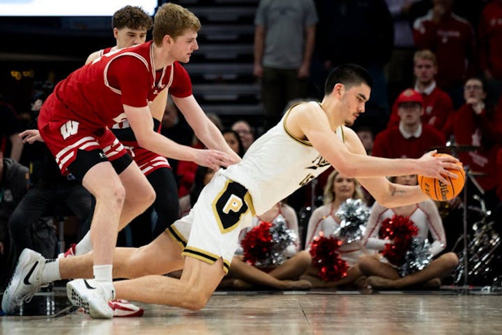 Purdue star Zach Edey (15) drew a foul against Wisconsin's Steven Crowl during last Saturday's overtime loss to Wisconsin in the Big Ten tournament semifinals at Target Center. (Angelina Katsanis, Star Tribune)