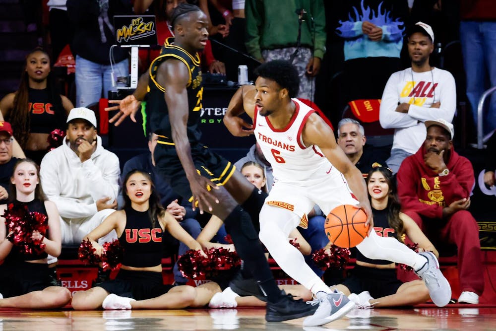 Los Angeles, CA - December 10: USC Trojans guard Bronny James (6) handles the ball while Long Beach State 49ers forward Aboubacar Traore (25) defends during the first half at Galen Center in Los Angeles Sunday, Dec. 10, 2023. (Jason Armond / Los Angeles Times)