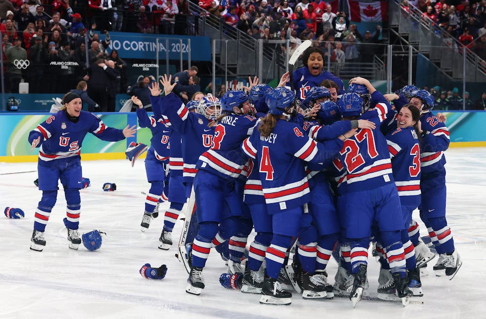 Team USA celebrates Megan Keller's overtime goal to win the Women's Gold Medal match between the United States and Canada on day 13 of the Milano Cortina 2026 Winter Olympic games at Milano Santagiulia Ice Hockey Arena on Feb. 19, 2026, in Milan, Italy. (Robert Gauthier/Los Angeles Times/TNS)