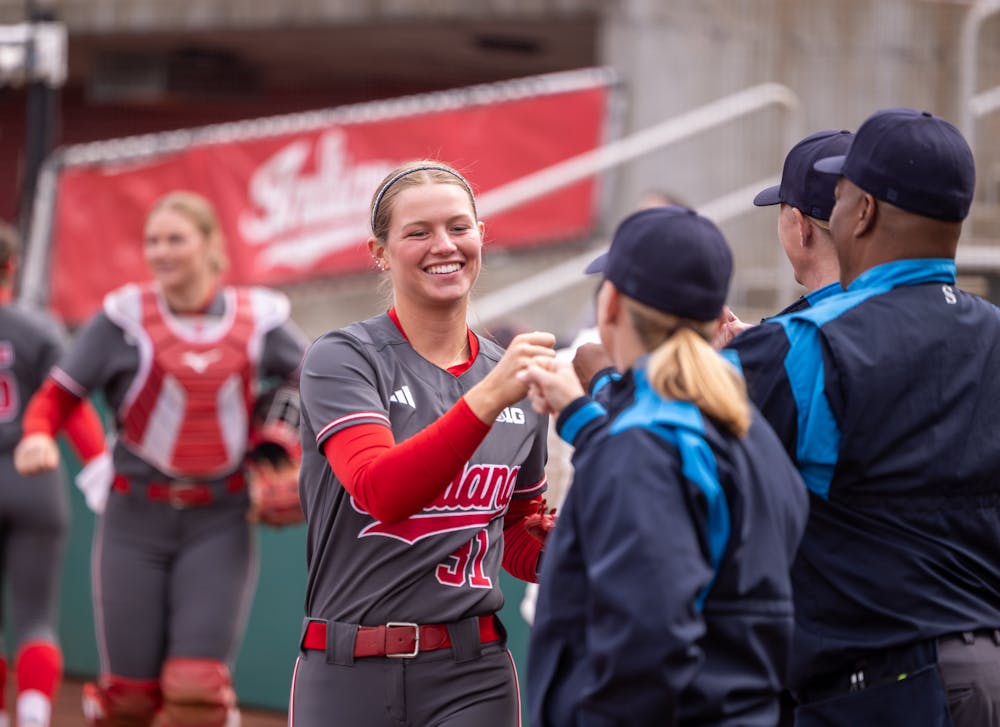 Alex Cooper daps up the umpire crew during Indiana's win over Rutgers on March 14, 2026. (HN photo/Lindsey Soet)