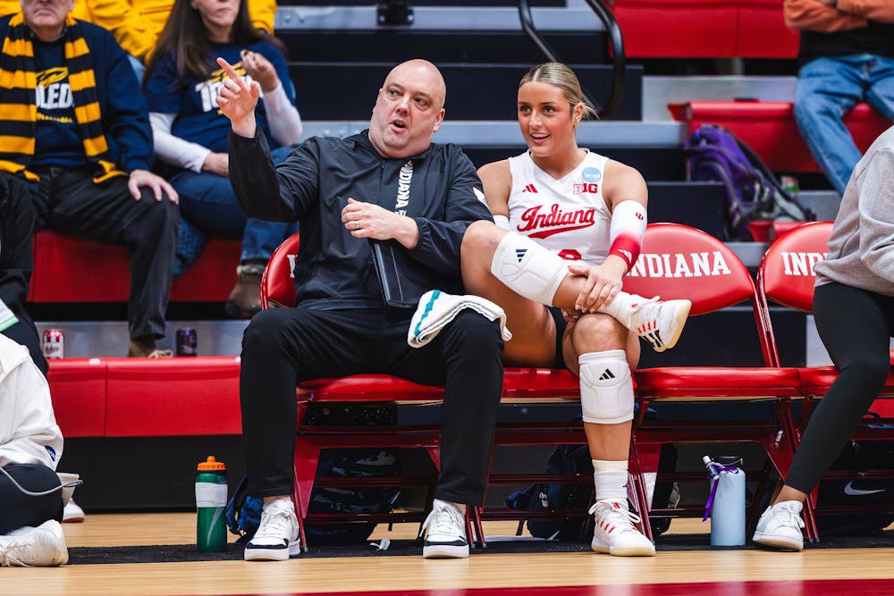 Indiana head volleyball coach Steve Aird speaks to Victoria Gray during Indiana's win over Toledo in the NCAA Tournament on Dec. 4, 2025. (HN photo/Kallan Graybill)