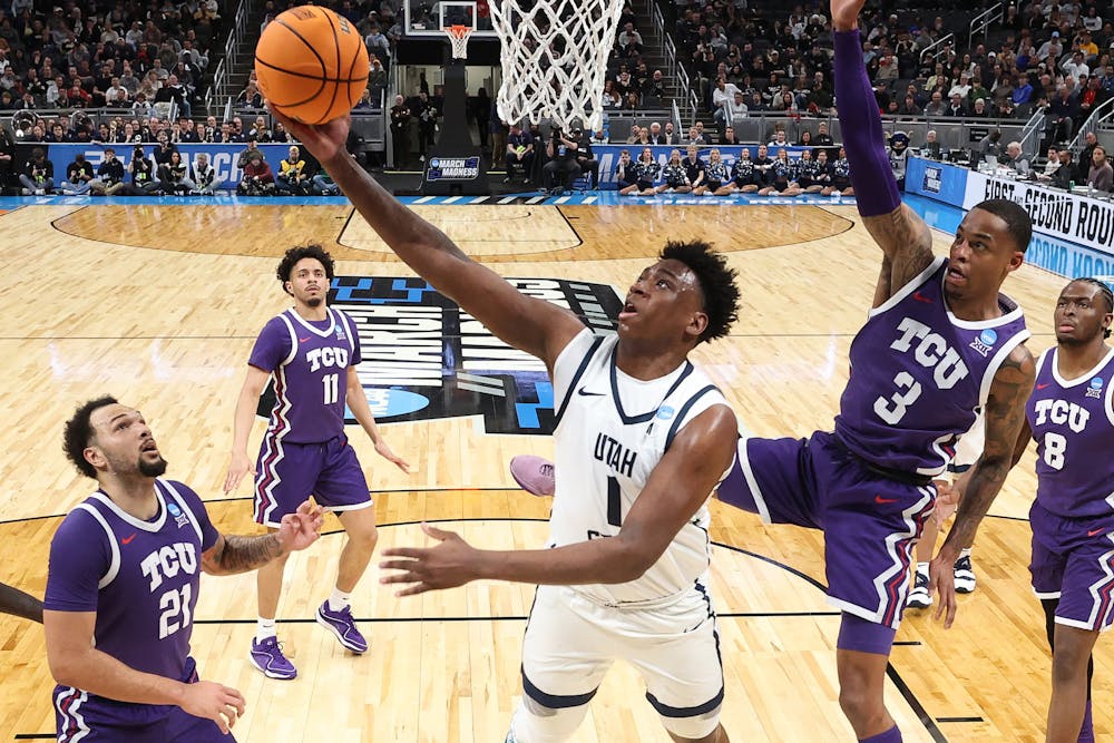 Utah State's Great Osobor (1) shoots the ball over Texas Christian's Avery Anderson III (3) in the first half during the first round of the NCAA Tournament at Gainbridge Fieldhouse on Friday, March 22, 2024, in Indianapolis. (Andy Lyons/Getty Images/TNS)