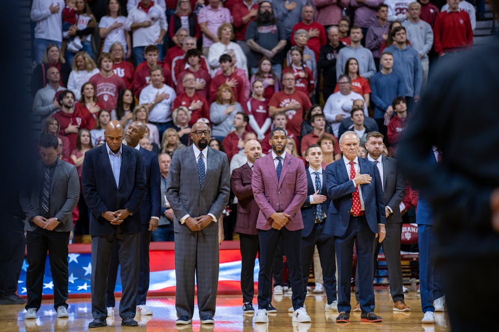 <p>Mike Woodson and I﻿U coaches await the national anthem on Nov. 16, 2024. (HN photo/Danielle Stockwell)</p>