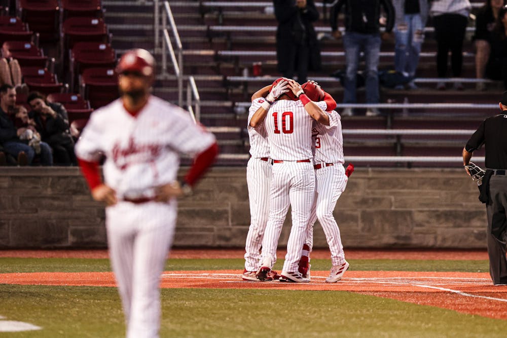 Indiana players celebrate at home plate versus Purdue Fort Wayne on February 27, 2024. (Photo via Indiana Athletics)