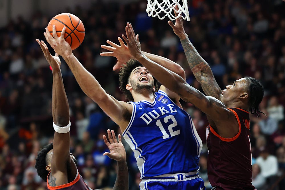 Duke's Cameron Boozer (12) shoots over Virginia Tech's Tobi Lawal (1) in the second half at Cassell Coliseum on Saturday, Jan. 31, 2026, in Blacksburg, Virginia. (Ryan Hunt/Getty Images/TNS)