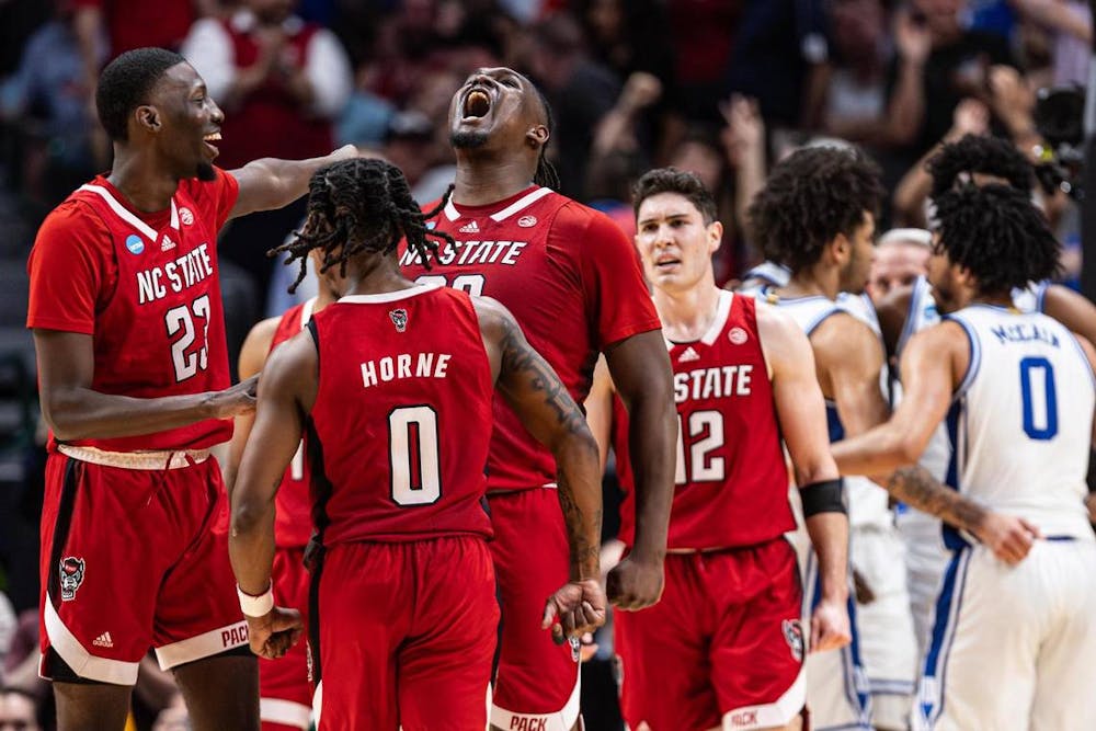 NC State forward DJ Burns Jr. (30) celebrates with his teammates after making a shot while getting fouled late in the second half of the Elite 8 South Regional Championship game of NCAA Division I Men's Basketball Tournament at American Airlines Center in Dallas on Sunday, March 31, 2024. NC State defeated Duke 76-64. (Chris Torres/Tribune Content Agency)