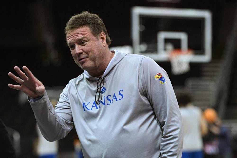 Kansas head coach Bill Self talks with a reporter while the Jayhawks take to the court for practice in preparation for the Men’s Big 12 Conference Tournament. (Rich Sugg/The Kansas City Star/TNS)
